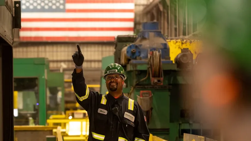 CNC technician operating five-axis machining center — technical talent in manufacturing at work.